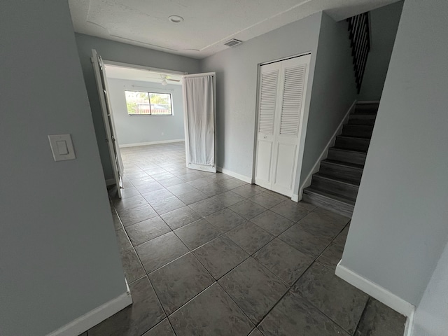 interior space with visible vents, stairway, and baseboards