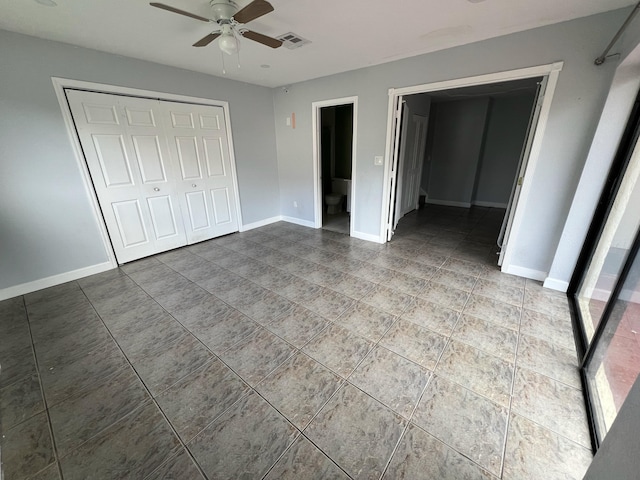 unfurnished bedroom with baseboards, visible vents, ceiling fan, and a closet