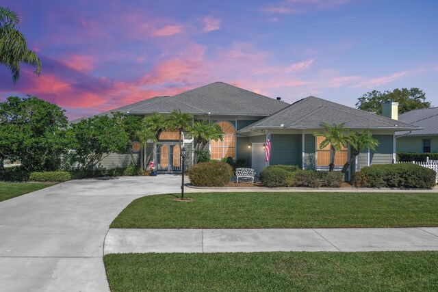 4408 Gator Trace Ln, Fort Pierce, FL 34982 - single story home featuring a front yard, roof with shingles, a chimney, and concrete driveway