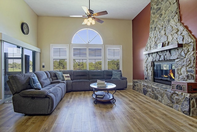 4408 Gator Trace Ln, Fort Pierce, FL 34982 - living room featuring a ceiling fan, a fireplace, hardwood / wood-style flooring, and a high ceiling