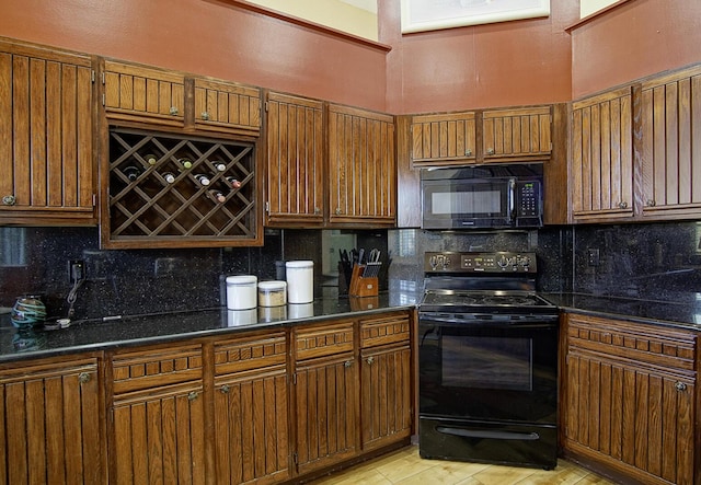 kitchen with black appliances, tasteful backsplash, brown cabinetry, and dark stone countertops