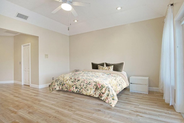 bedroom featuring a ceiling fan, baseboards, visible vents, and light wood finished floors