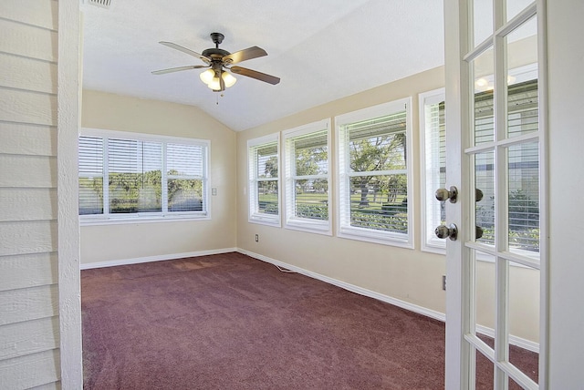 unfurnished sunroom with lofted ceiling, ceiling fan, and visible vents