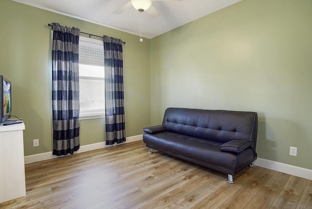 sitting room featuring ceiling fan, baseboards, and wood finished floors