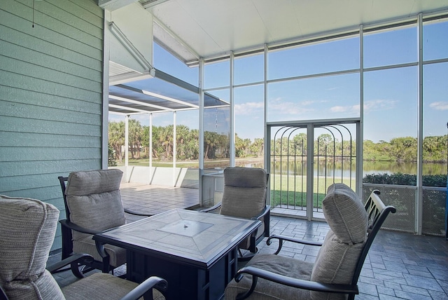 sunroom / solarium with a water view