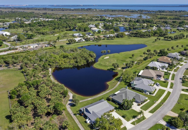 aerial view featuring golf course view, a water view, and a residential view