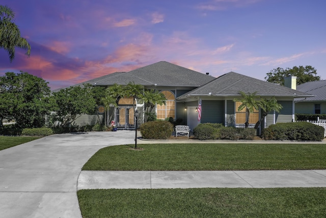 4408 Gator Trace Ln, Fort Pierce, FL 34982 - ranch-style home with a front lawn, roof with shingles, and driveway