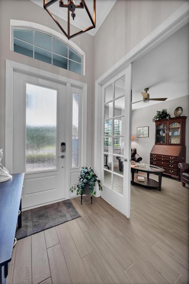 entrance foyer with a notable chandelier, a high ceiling, and wood finished floors