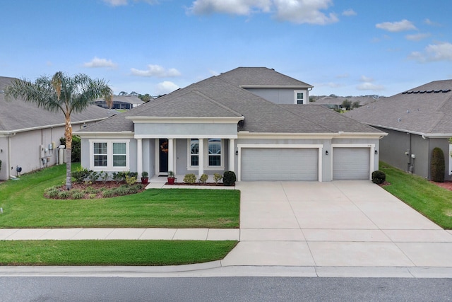 view of front of house featuring a garage, driveway, a shingled roof, a front lawn, and stucco siding