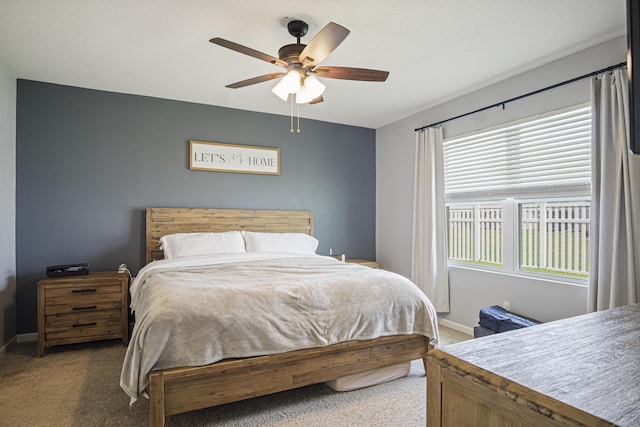 bedroom featuring ceiling fan, carpet, and baseboards