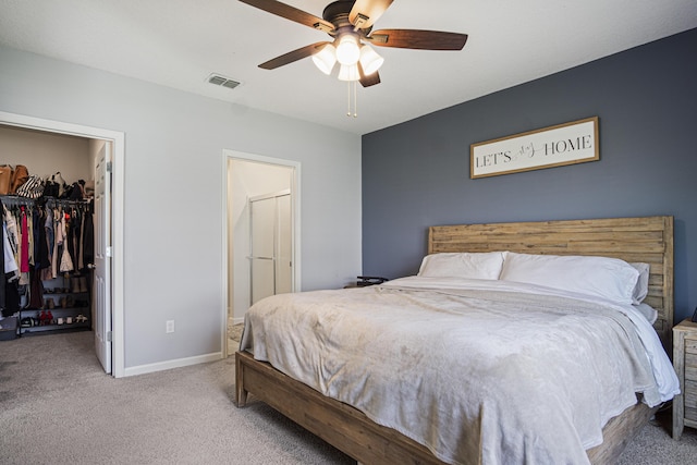 bedroom with visible vents, baseboards, a spacious closet, a closet, and carpet