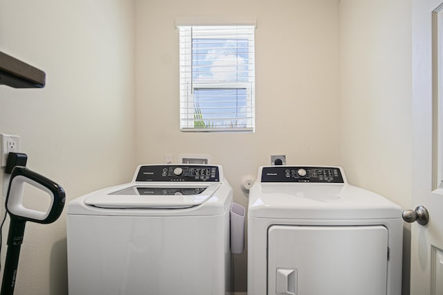 laundry room featuring laundry area, washer and clothes dryer, and plenty of natural light