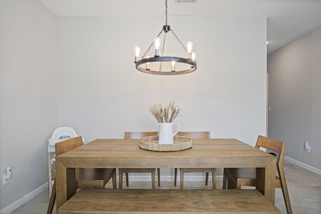 dining area with an inviting chandelier and baseboards