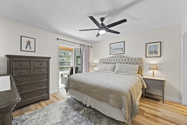 bedroom with light wood finished floors, ceiling fan, a textured ceiling, access to outside, and baseboards