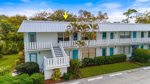 2929 SE Ocean Blvd Unit 10510, Stuart, FL 34996 - view of building exterior with uncovered parking and stairway