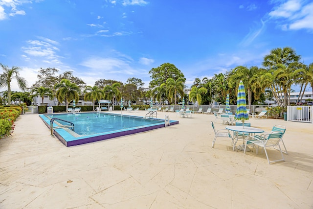 pool featuring a patio area and fence