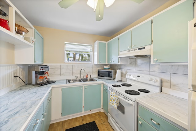 kitchen with white range with electric cooktop, stainless steel microwave, under cabinet range hood, open shelves, and a sink