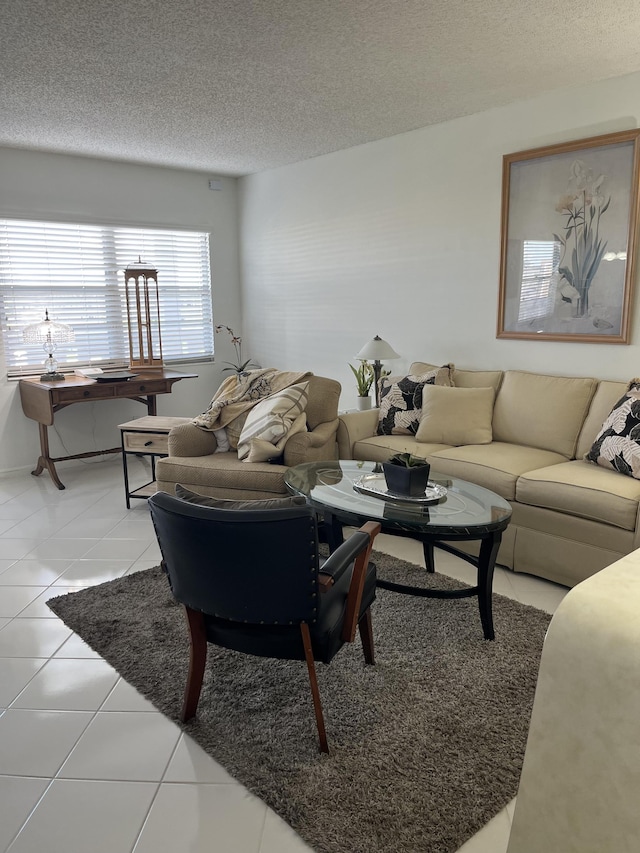 living area with light tile patterned floors and a textured ceiling