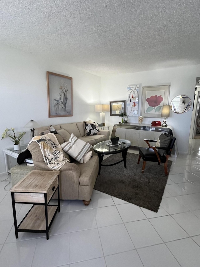 living area featuring a textured ceiling and tile patterned floors