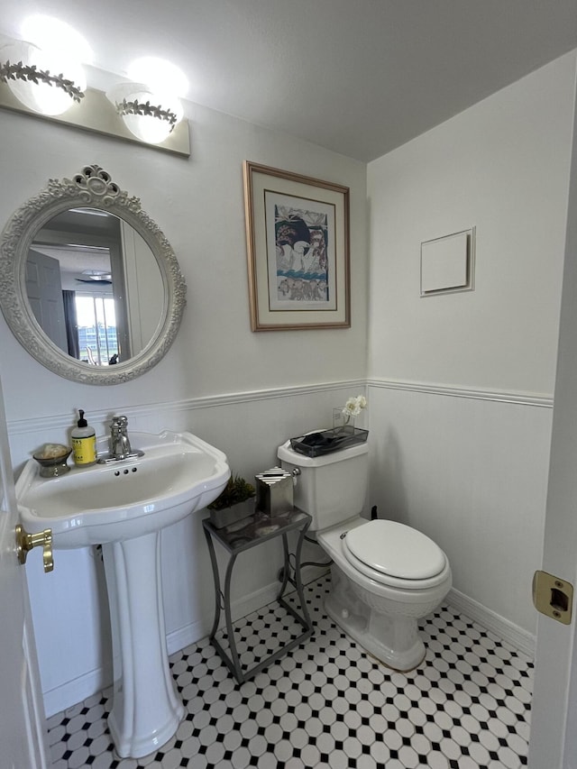 4062 Guildford D, Boca Raton, FL 33434 - half bath featuring toilet, tile patterned flooring, baseboards, and a sink