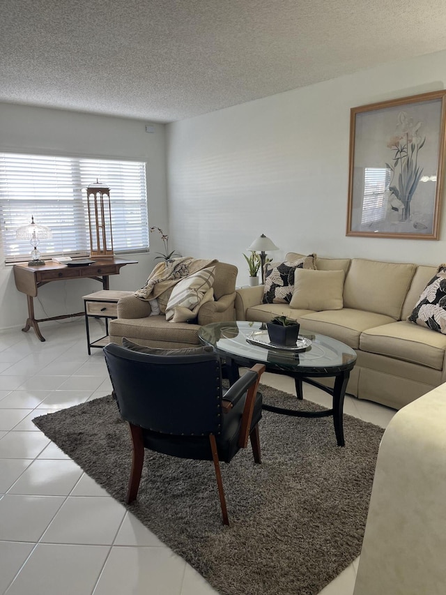 living area with a textured ceiling and light tile patterned floors