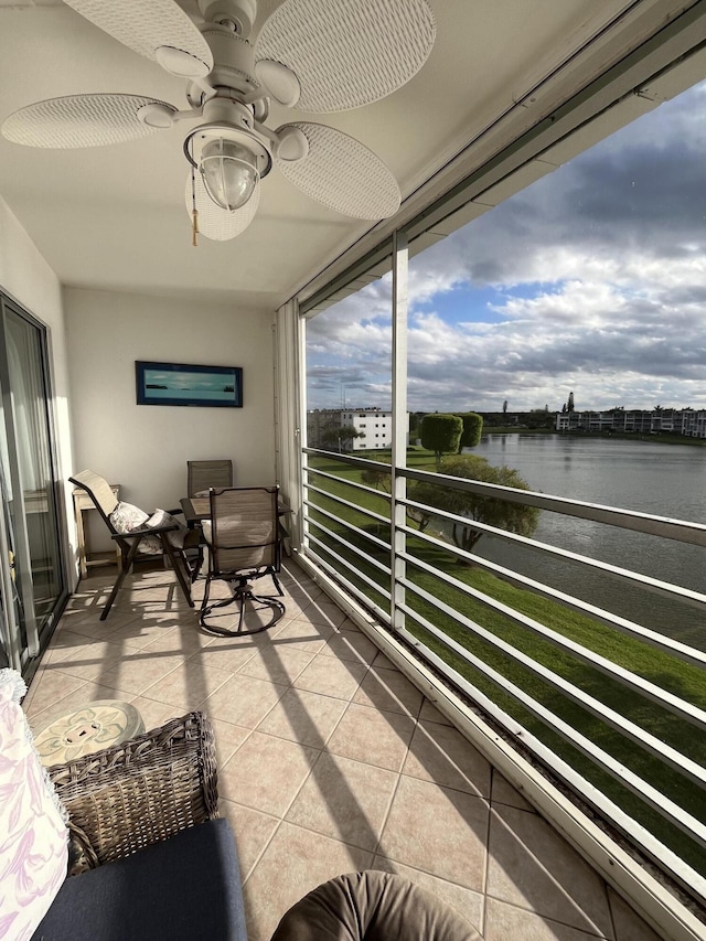 balcony with a water view and ceiling fan