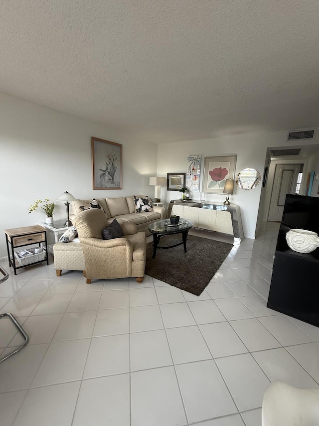4062 Guildford D, Boca Raton, FL 33434 - living room with a textured ceiling, visible vents, and light tile patterned flooring