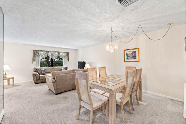 dining room with baseboards, a textured ceiling, visible vents, and carpet flooring