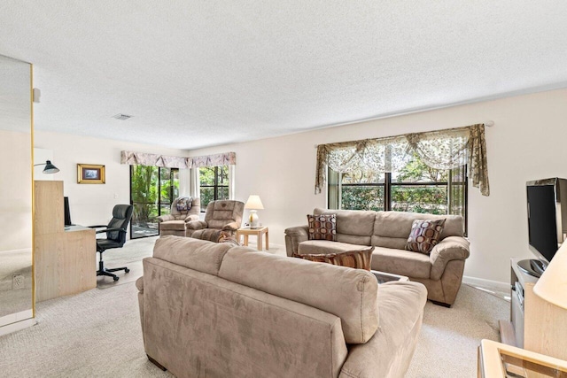 living room featuring a textured ceiling, baseboards, visible vents, and light colored carpet