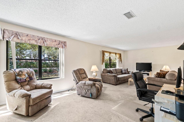 office area featuring carpet, visible vents, and a textured ceiling