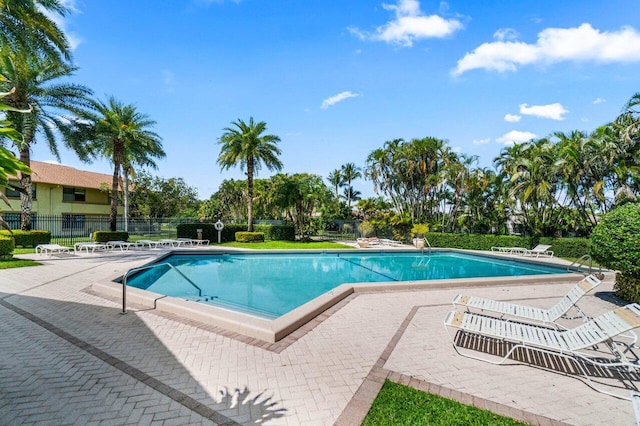 community pool featuring a patio and fence