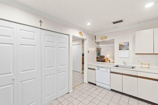 kitchen featuring white dishwasher, a sink, visible vents, white cabinetry, and light countertops