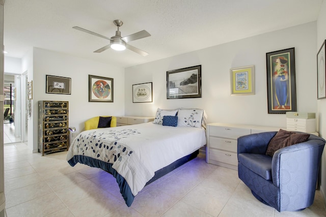 bedroom with light tile patterned flooring, a textured ceiling, and ceiling fan