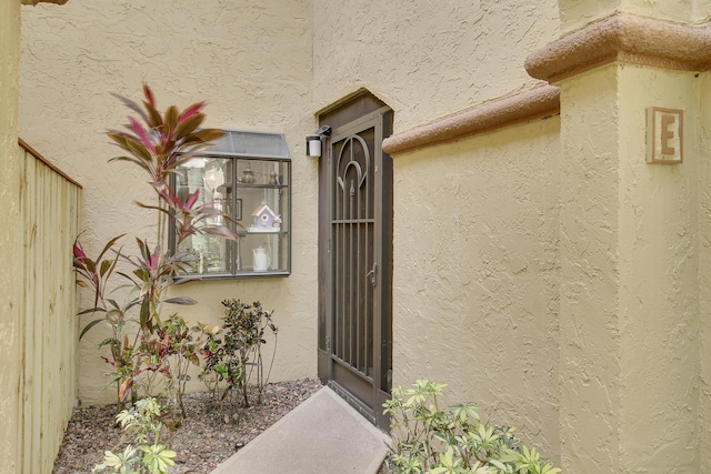 property entrance with stucco siding