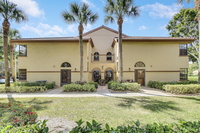 exterior space with a front lawn and stucco siding