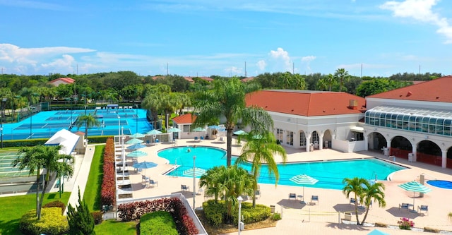 community pool featuring a patio area and fence