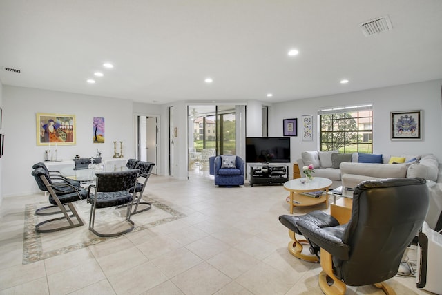 living room with plenty of natural light, visible vents, and recessed lighting