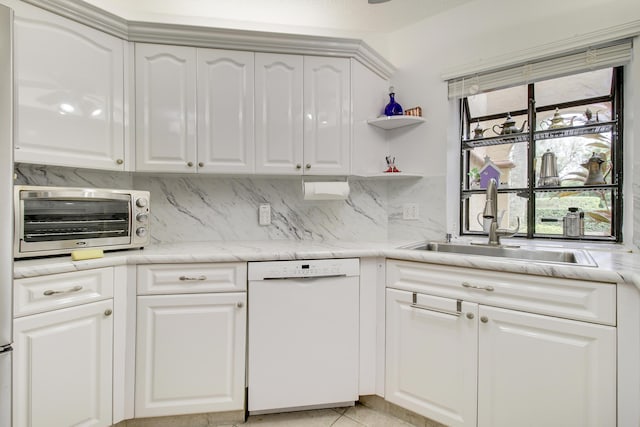 kitchen with a toaster, a sink, white cabinetry, backsplash, and dishwasher