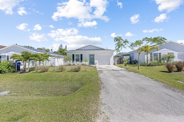 view of front of house featuring a garage, driveway, a front lawn, and fence