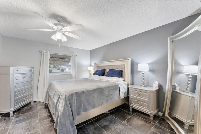 bedroom featuring a ceiling fan and a textured ceiling