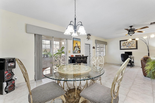 dining area with light tile patterned floors, baseboards, visible vents, and a ceiling fan