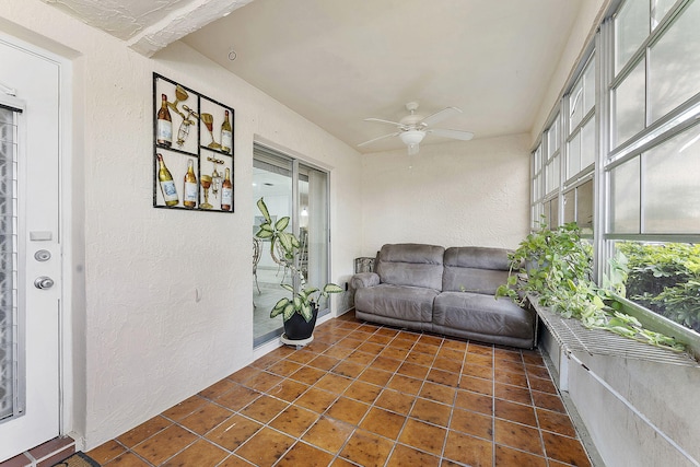 sunroom featuring a ceiling fan