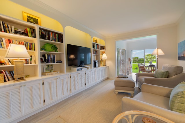 living area featuring light wood-style floors and crown molding