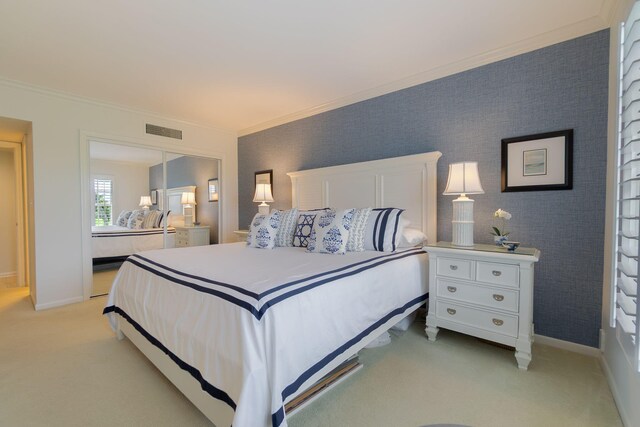 bedroom with light carpet, wallpapered walls, baseboards, and crown molding