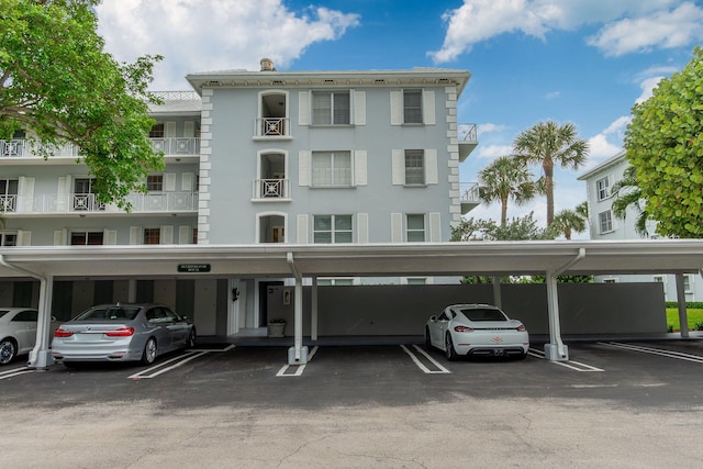 view of building exterior featuring covered parking