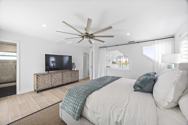 bedroom featuring ceiling fan, recessed lighting, baseboards, light wood finished floors, and ensuite bath