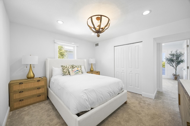 bedroom featuring recessed lighting, light carpet, visible vents, a closet, and an inviting chandelier