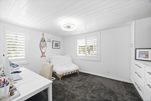 office with dark carpet, wood ceiling, and baseboards