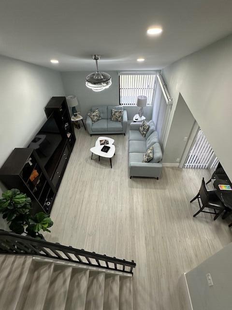 living area with wood finished floors and recessed lighting