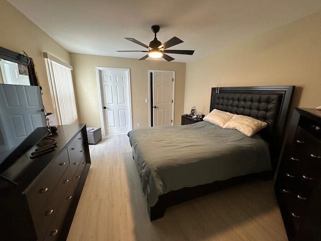 bedroom with a ceiling fan and light wood-type flooring